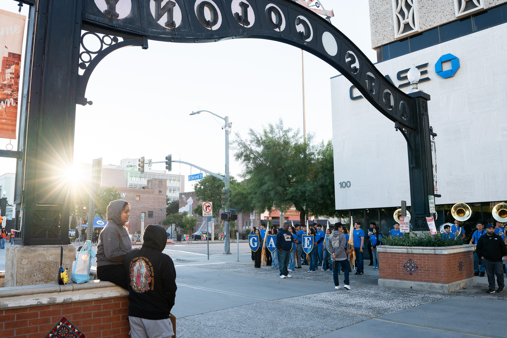 Marching band parade under the downtown Pomona arch